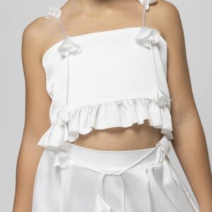Front view of cropped top with bow‑tie straps and ruffled hem